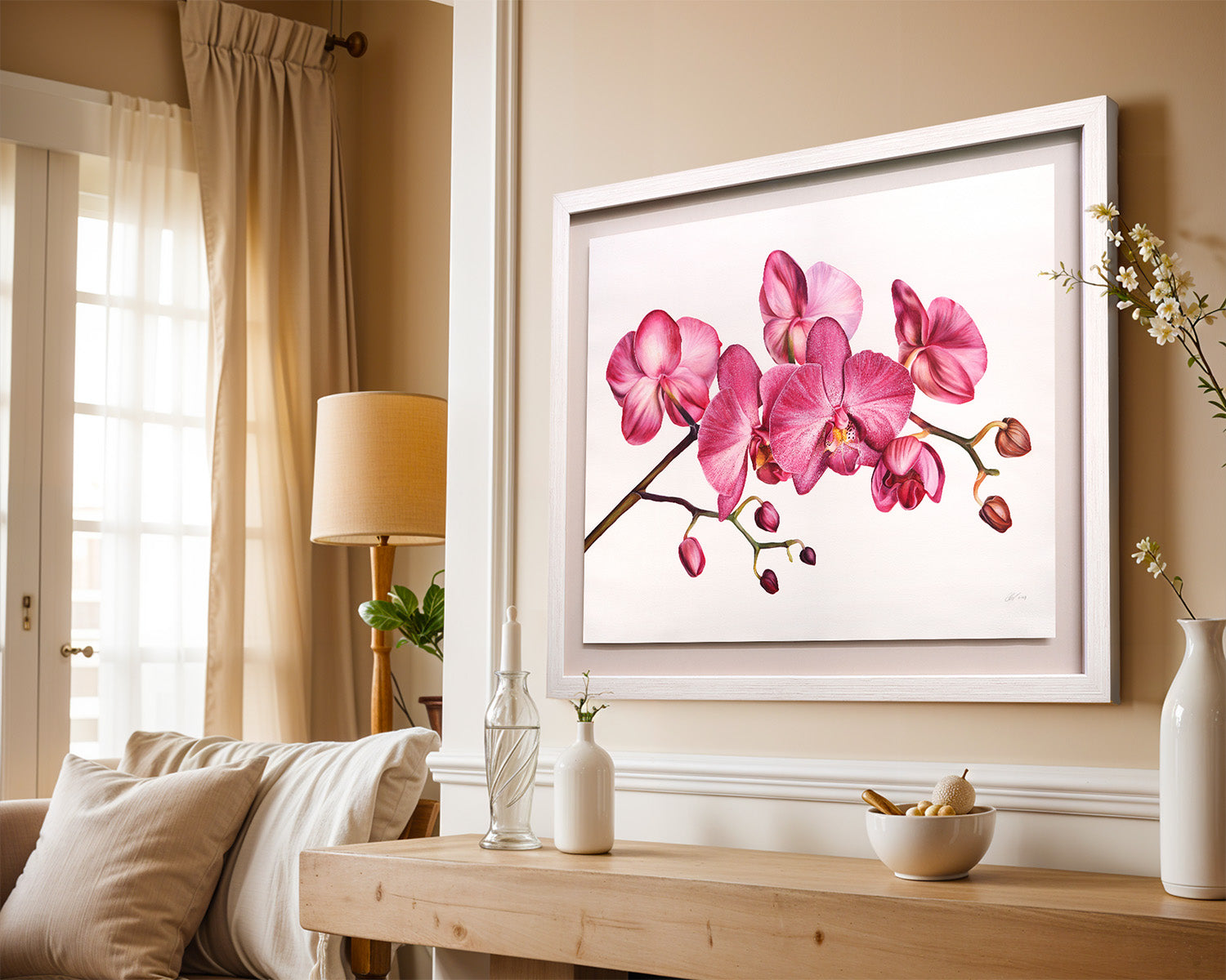 Framed artwork of pink orchids on a wall in a living room.